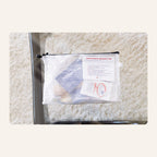 Contraception Educator's Kit mesh pouch with condom, IUD, and other contraception samples visible inside, and an itemized contents label
